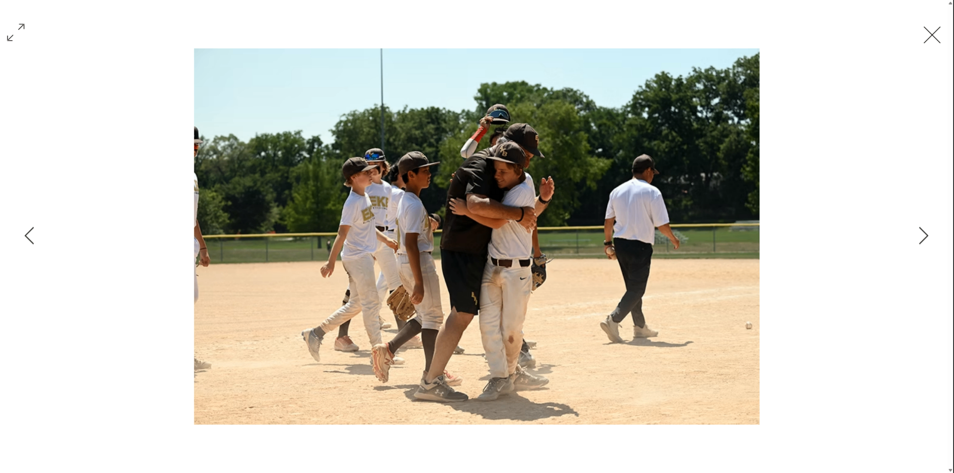 Elite Knights coach embracing a player after a win on the field